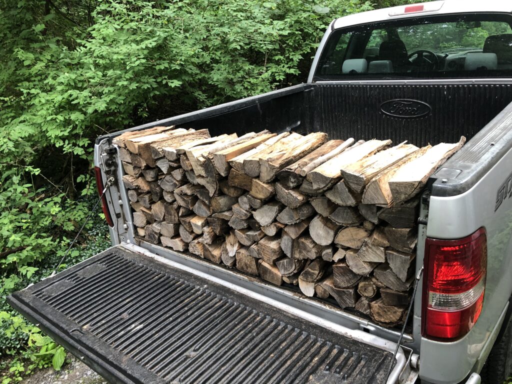 single row of seasoned Syracuse Firewood stacked on truckbed for delivery